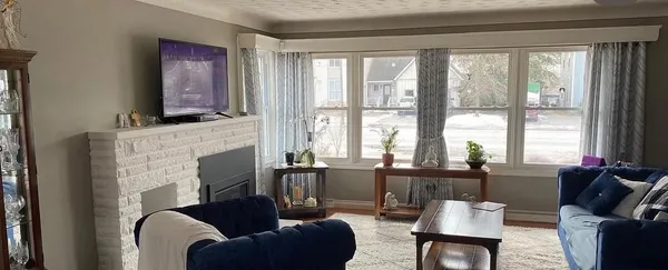 Living room with dated beige walls before Sarah repainted it