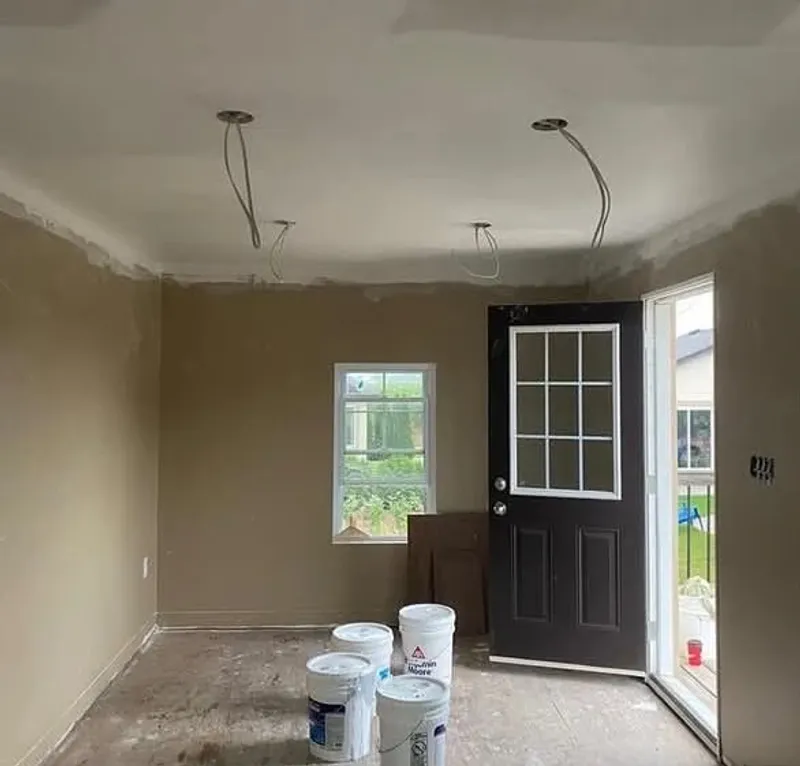 New build room with bare drywall and patchy primer