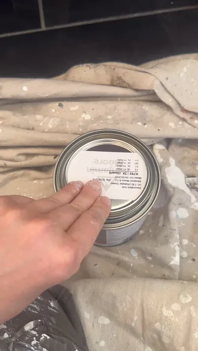 A quart of Benjamin Moore paint, mixed for a job, on a drop cloth