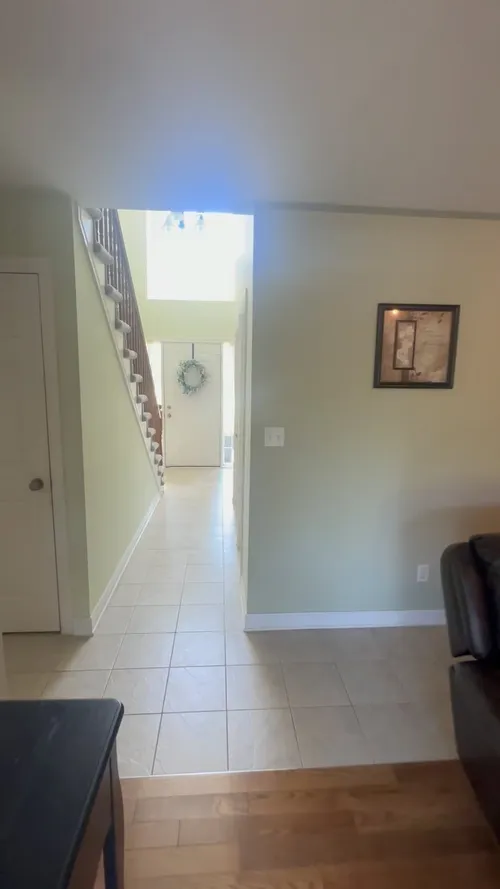 Soft sage walls from the living room to the front door and stairwell