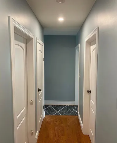 Blue-grey hallway with white doors
